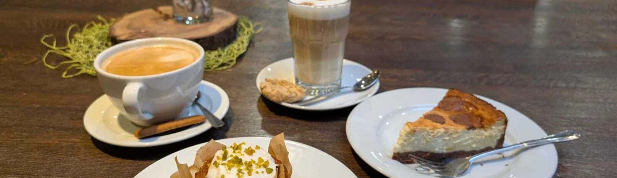 Auf einem Tisch stehen Tassen mit Kaffee und Teller mit Kuchen | © Kletterzentrum